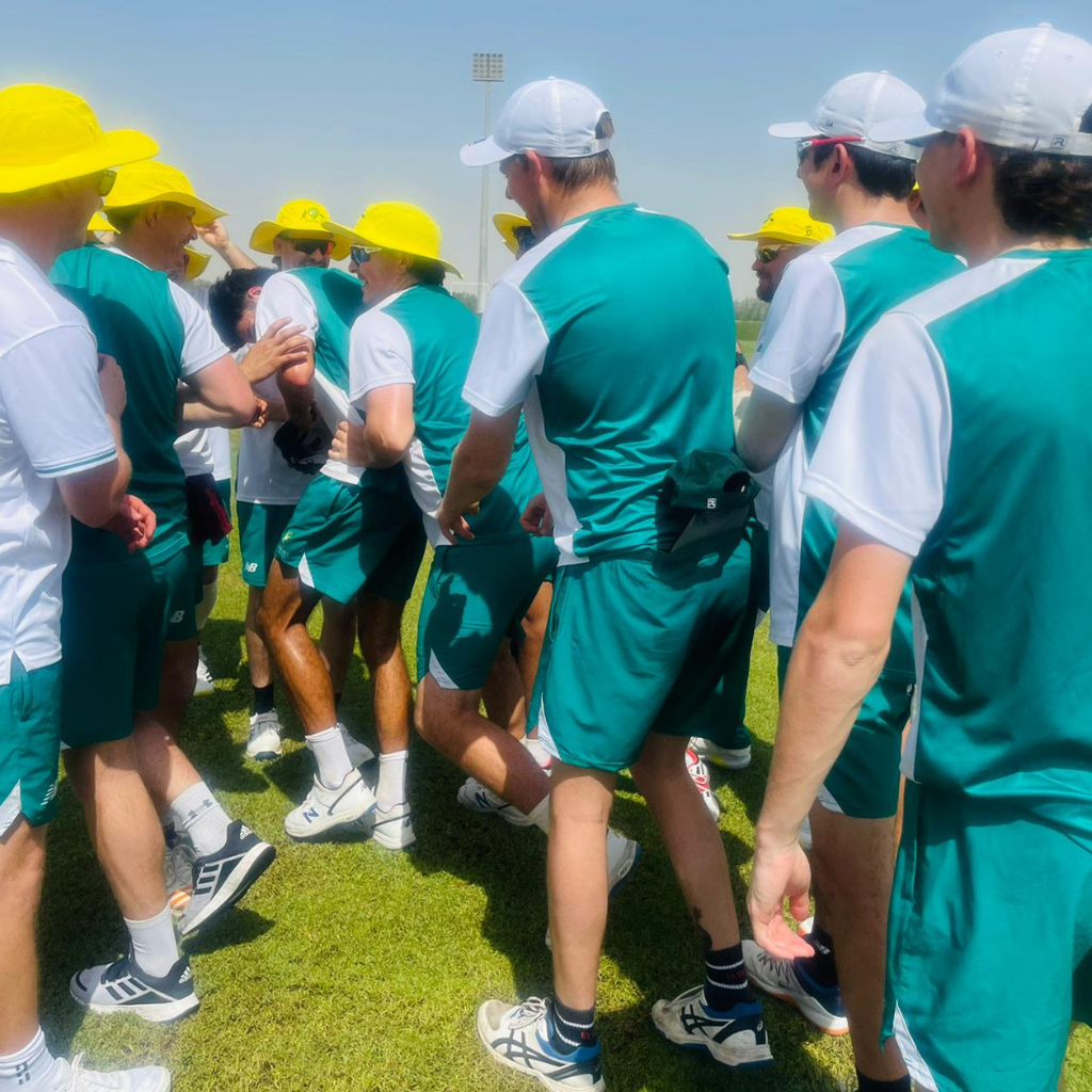 The 2024 Australian Deaf cricket team crowded together on the field.