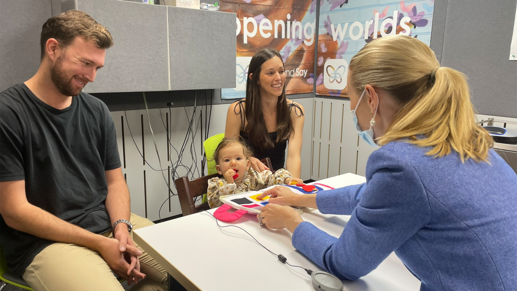 Baby and parents in speech and language assessment with speech pathologist.