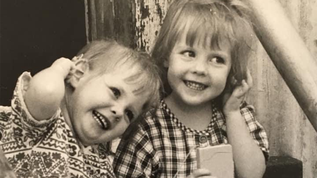 An old photo of Maddi when she was a child and another young child. The photo is in sepia.
