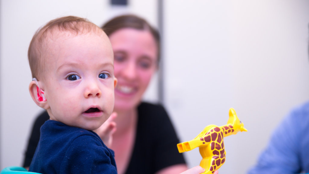 Boy With Hearing Aids In Speech Lesson
