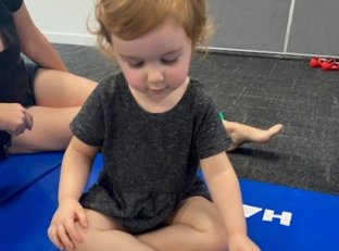 Img Girl Sitting Crossed Legged Looking Down