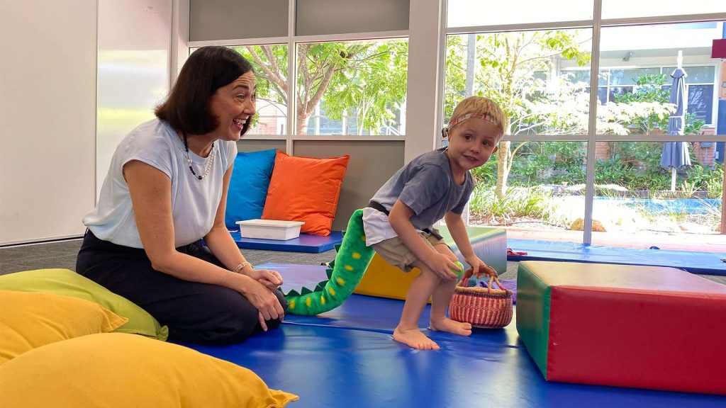 Occupational therapist playing with a young boy.